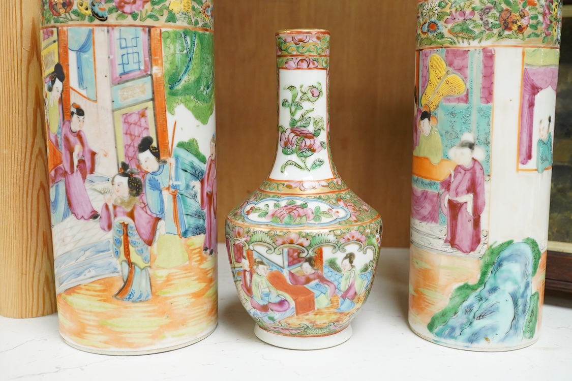 Two 19th century Chinese famille rose cylindrical vases and a similar bottle vase, 21cm